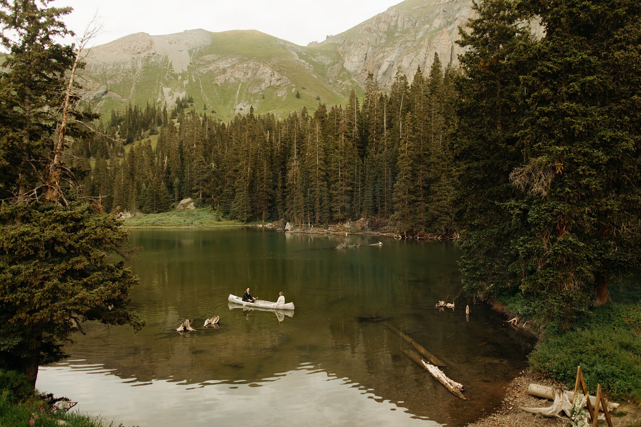 Bride and Groom riding in canoe at Alta Lakes Observatory