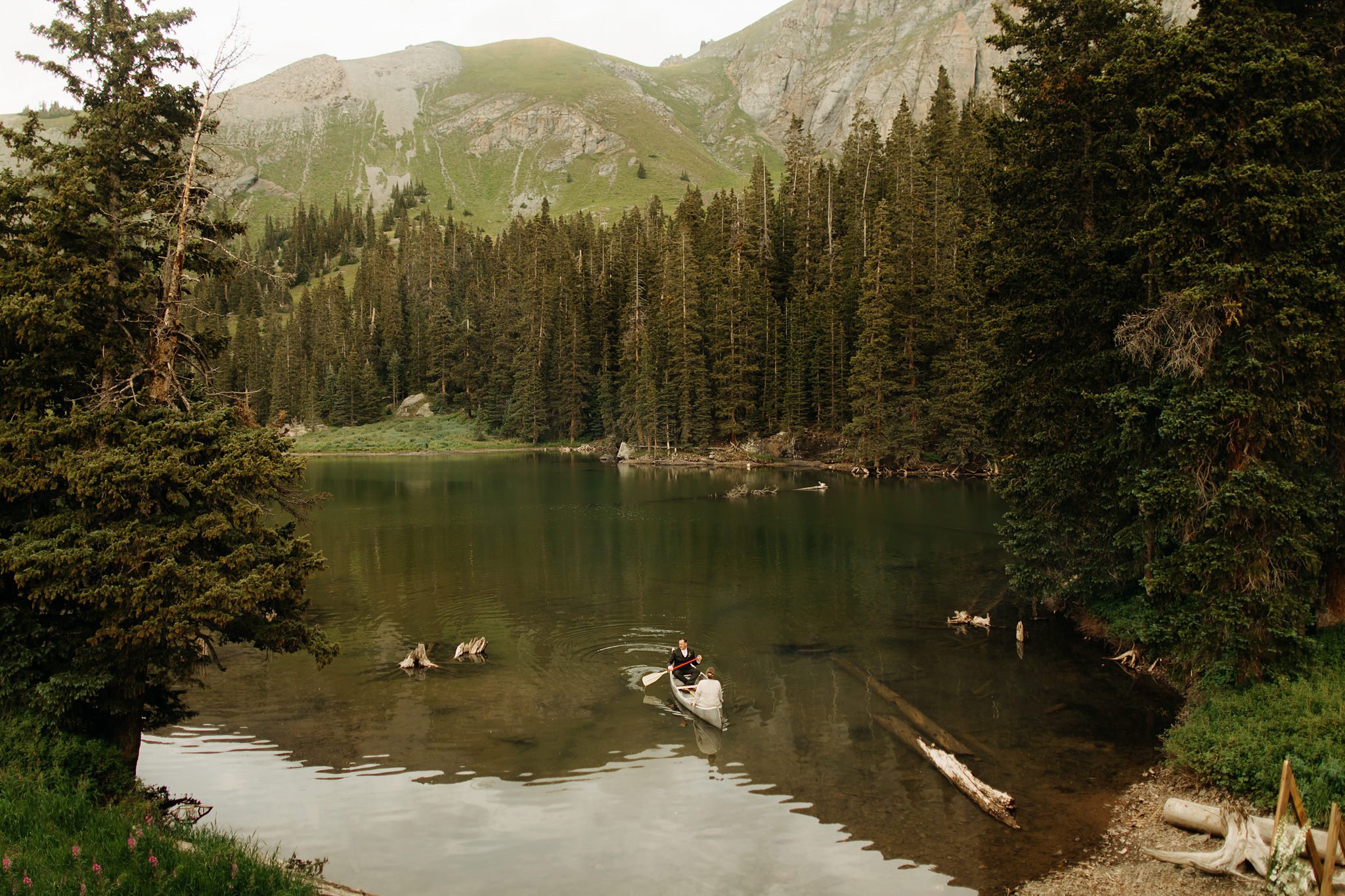 Bride and Groom riding in canoe at Alta Lakes Observatory