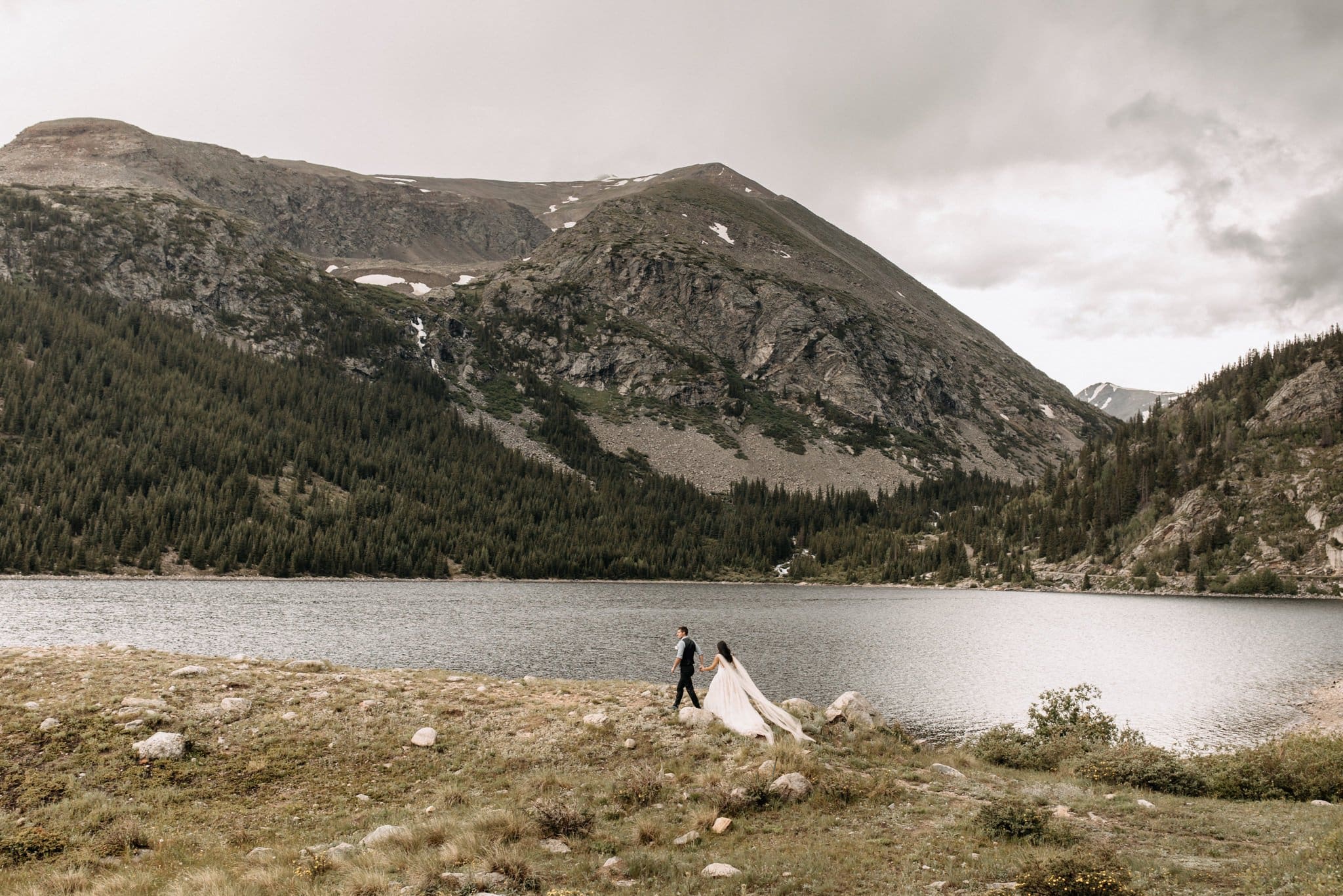 Wedding portraits by mountain lake in Breckenridge