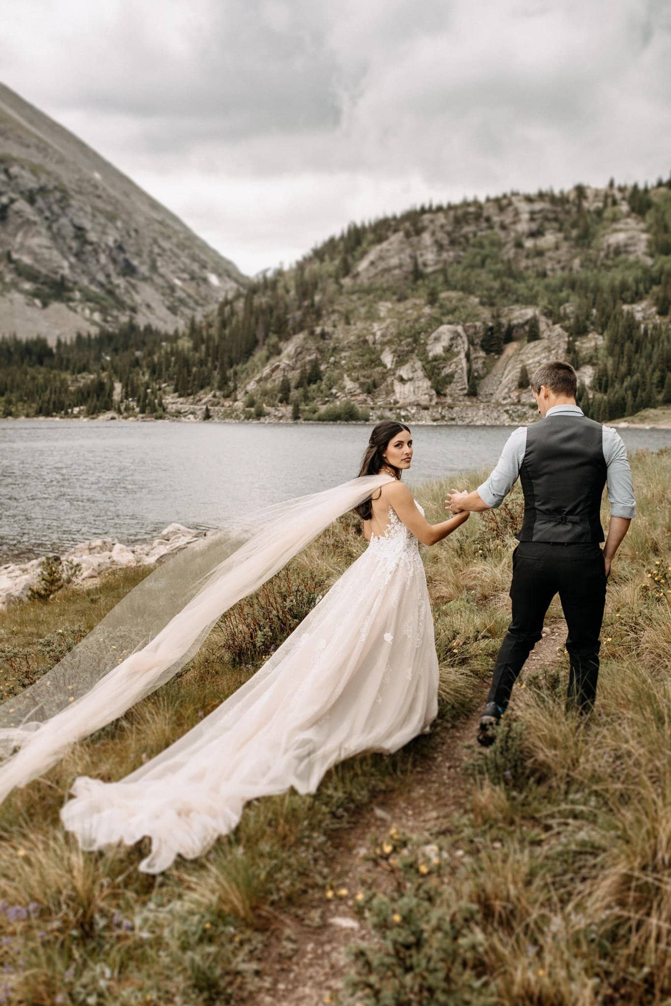 Wedding portraits by mountain lake in Breckenridge