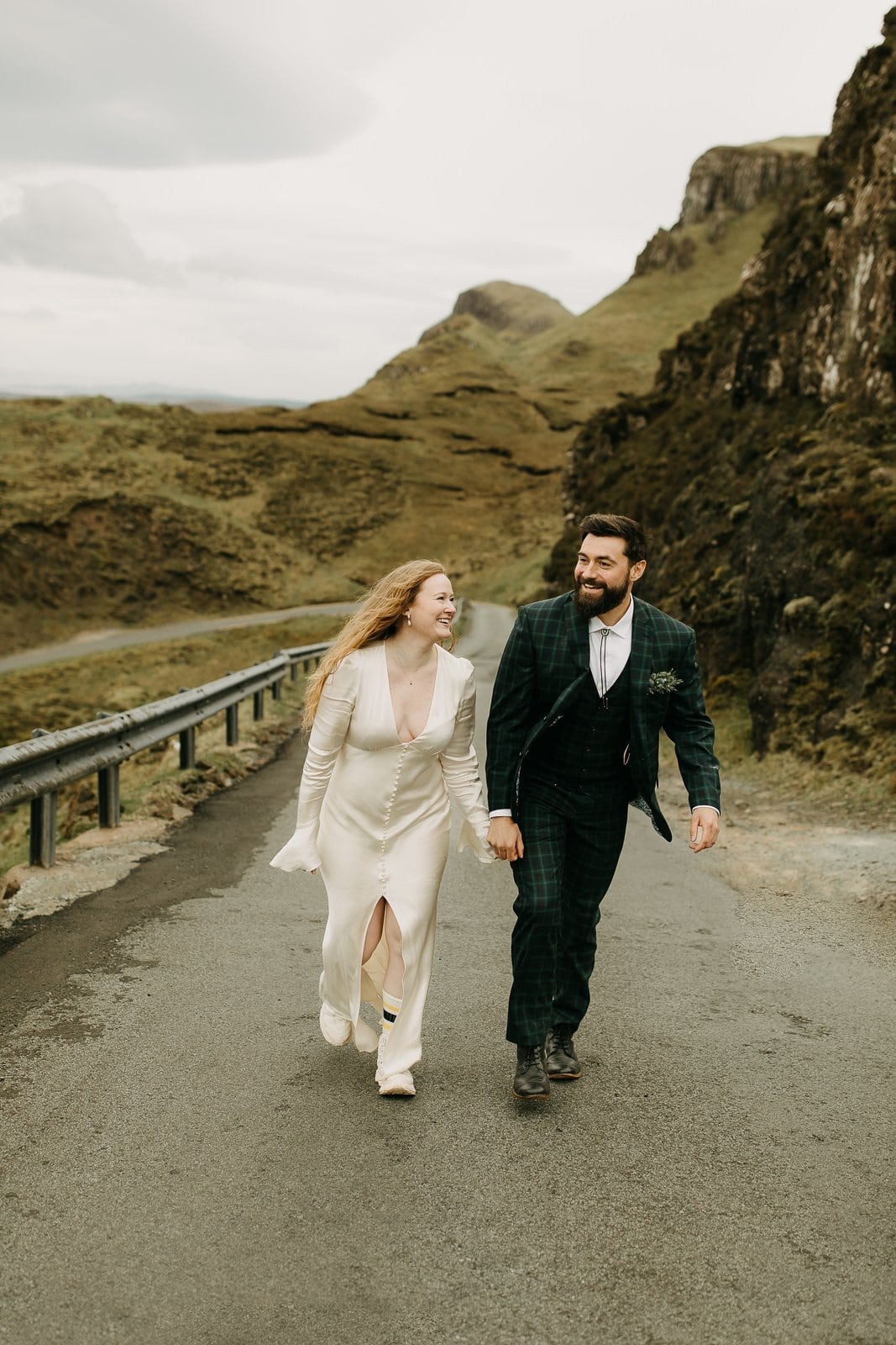 Couple walking down the road after eloping at the Quiraing, Isle of Skye