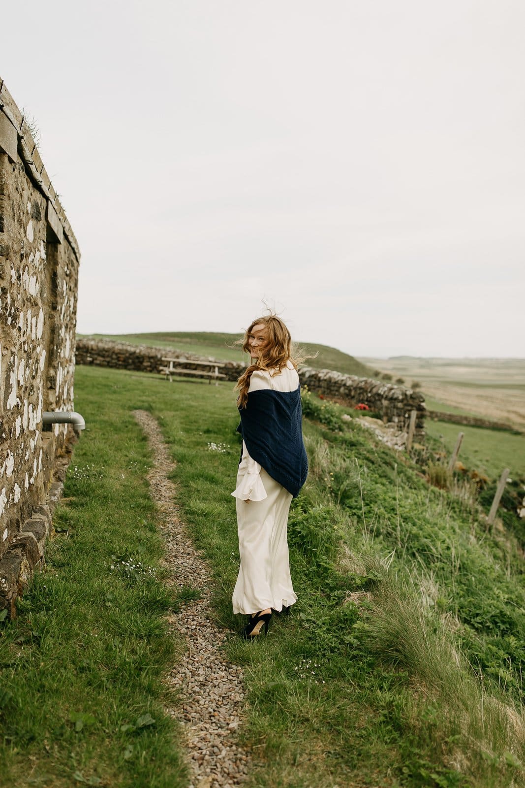 Bride walking to her first look at Monkstadt 1745 elopement, Isle of Skye